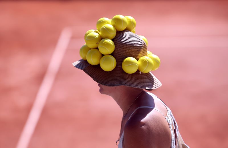 Tennis fan turns heads with ball hat during French Open