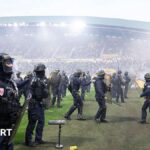Nantes-Toulouse abandoned after fans throw flares and invade pitch
