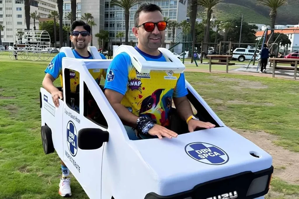 Duo chases Cape Town Marathon finish line in car costume